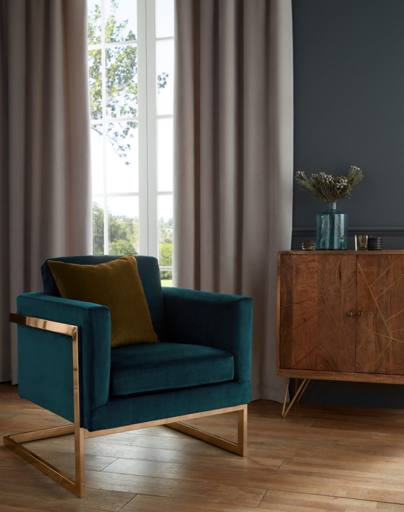 Denver Phoenix armchair with ahs grey curtains and wood sideboard