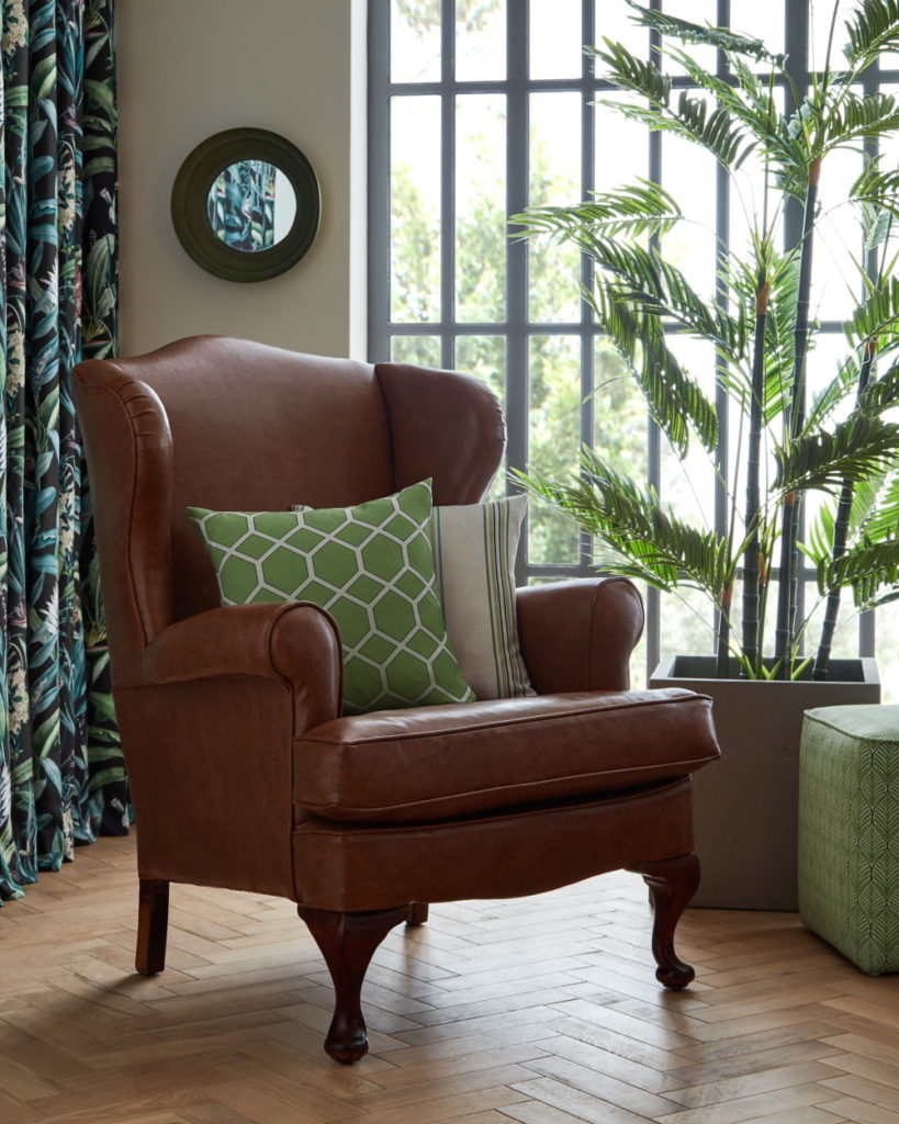 Leather armchair with emerald cameo fabric cushions