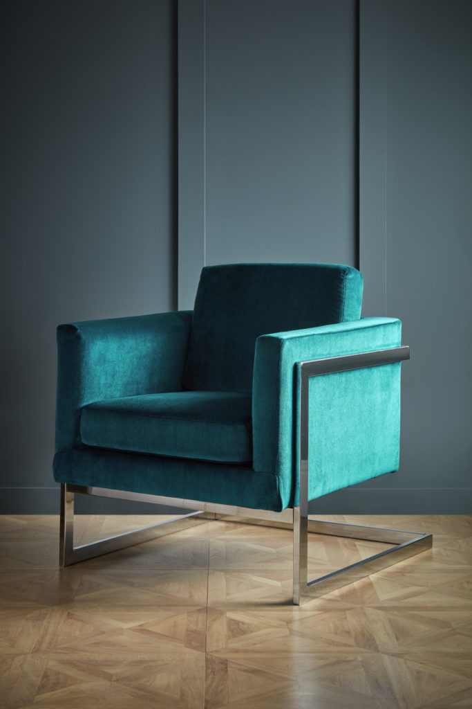 Denver covered armchair against wood panelling