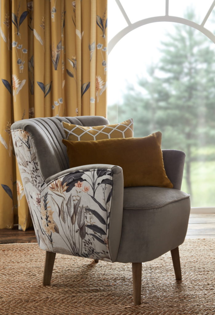 Ochre Cameo covered armchair with matching yellow curtains
